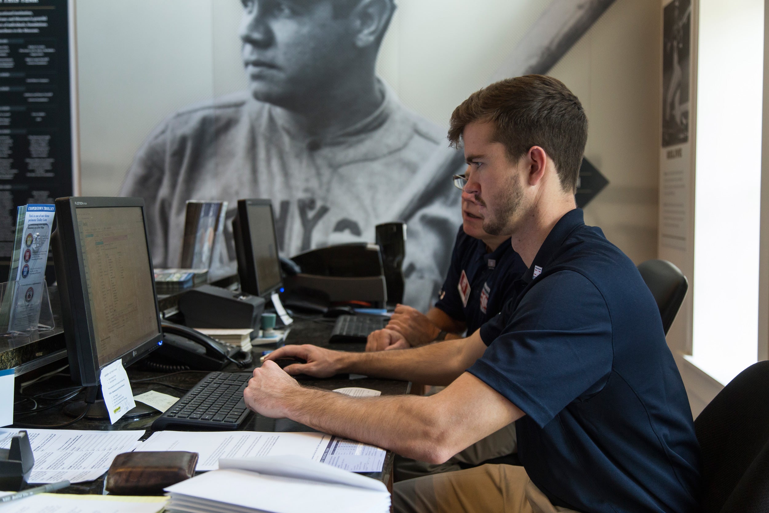 A Hall of Fame employee at the Museum information Desk